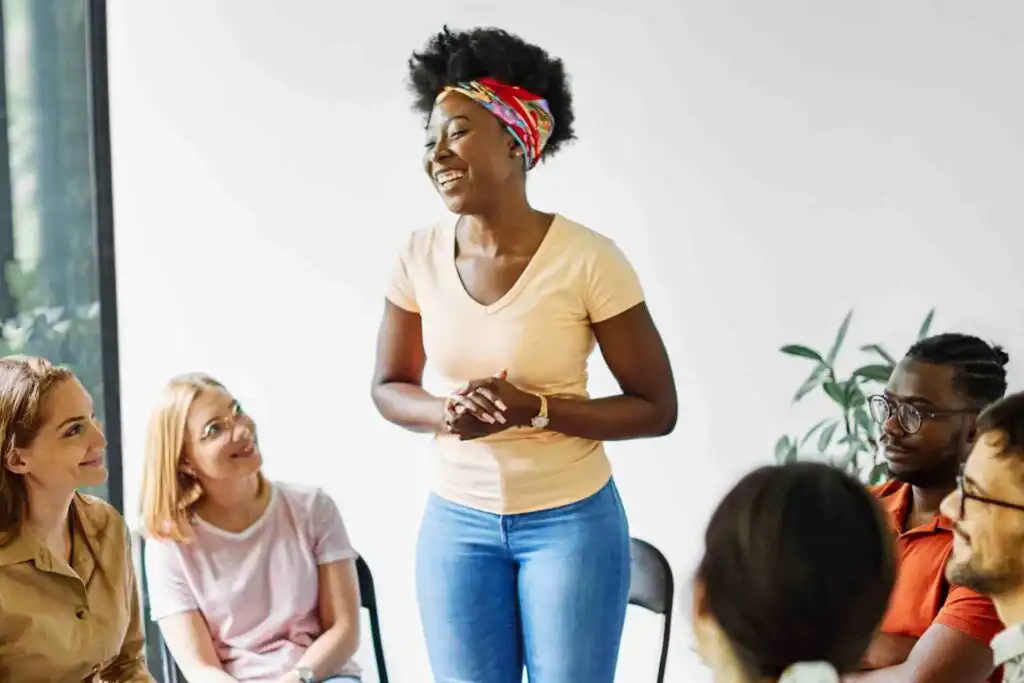 Woman speaking in group therapy session for addiction recovery