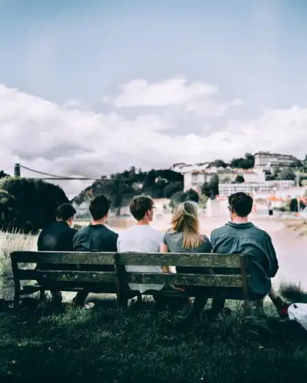 Group sitting on a bench discussing their dual diagnosis treatment