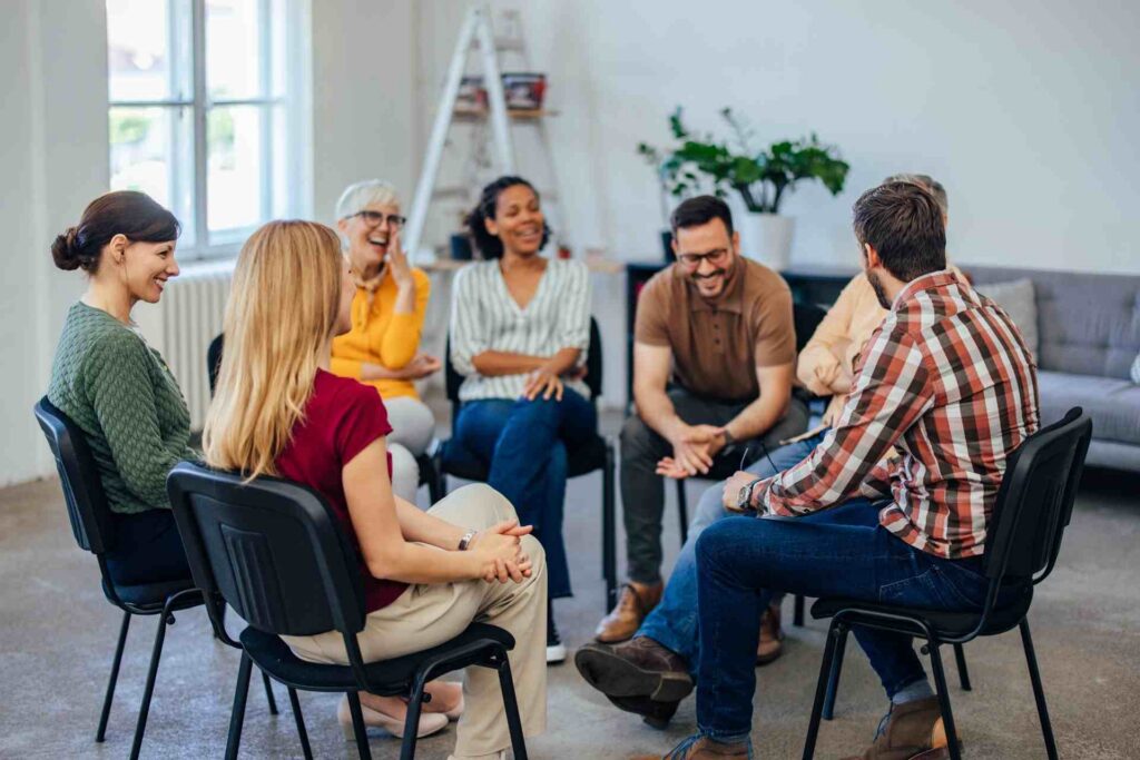Group therapy session for addiction recovery discussing rehab vs outpatient treatment options