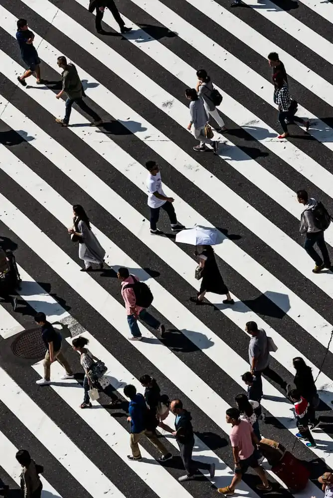 People walking in a cross walk to addiction treatment